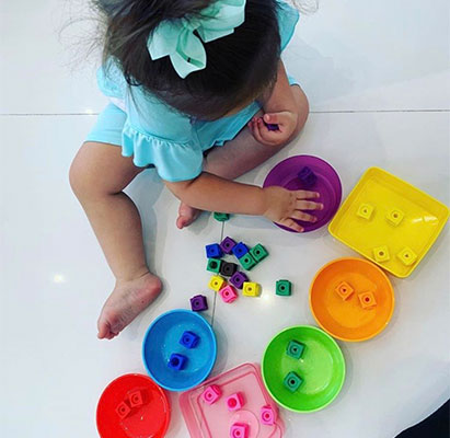 young girl playing with blocks